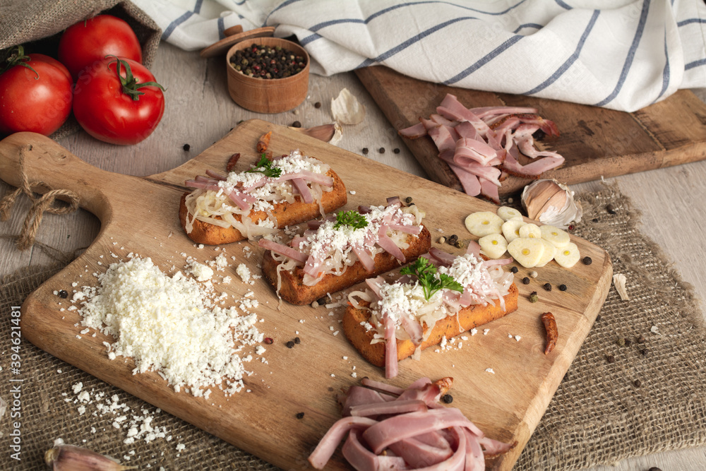 Bruschetta: homemade sheep's cheese, bacon, sauerkraut, garlic, homemade bread, herbs and spices. Italian food.