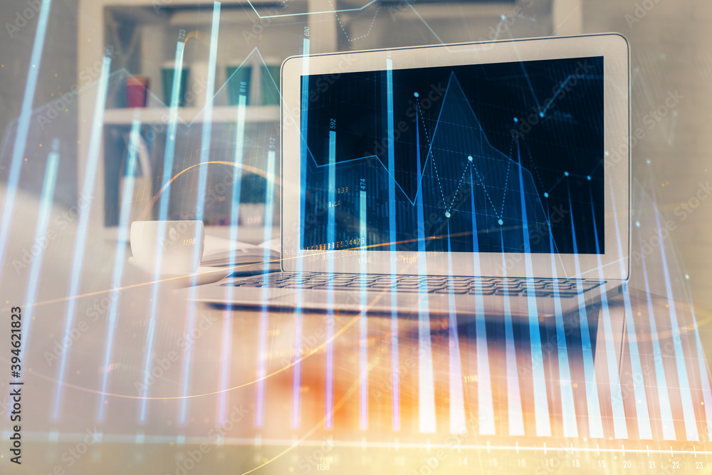Stock market graph and table with computer background. Multi exposure. Concept of financial analysis.