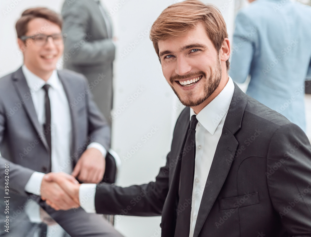happy entrepreneur shaking hands with his business partner happy entrepreneur shaking hands with his business partner