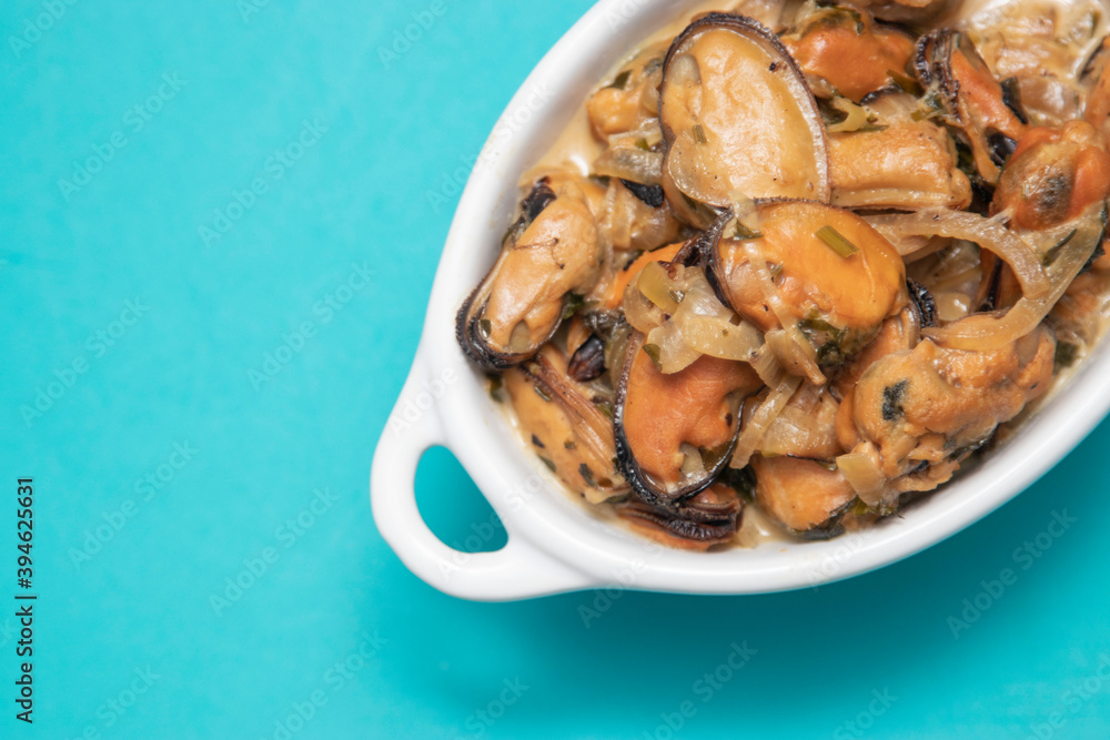 Mussels without shell slices in white ceramic bowl. Seafood concept. Selective focus. Space for text Mussels without shell slices in white ceramic bowl. Seafood concept. Selective focus. Space for text