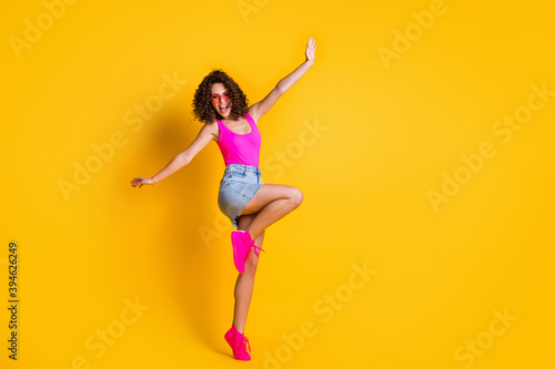 Full length photo of pretty crazy wavy hairdo lady hands up air summer holidays youth party wear heart shape sun glasses pink tank top denim mini skirt shoes isolated vivid color background