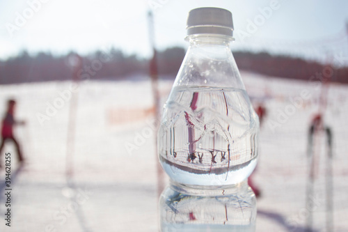 bottle of water on background, Ski park in Poland. New Year. People go skiing, go to the chair lift.