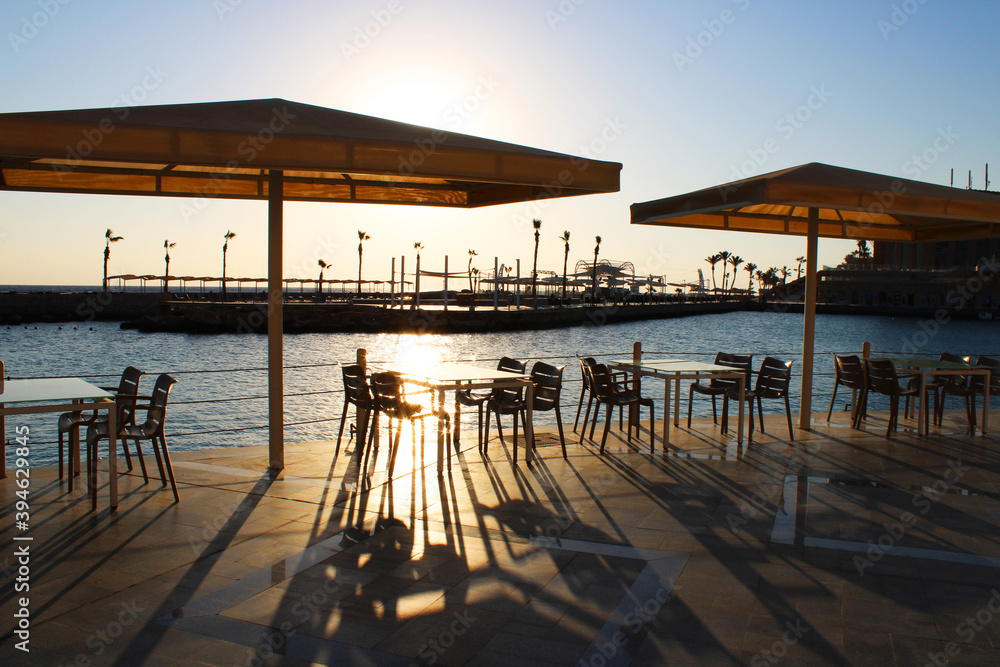 Tables under an umbrella for relaxation and dining at the marina