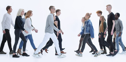 in full growth. diverse young people walking in different directions.