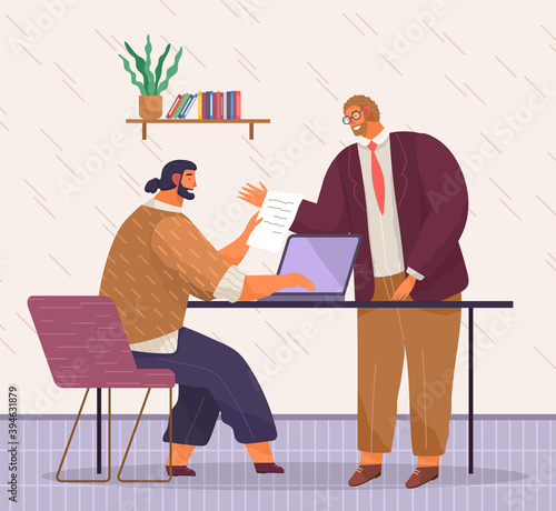 Bearded man with fashionable haircut sits on chair, works at laptop, typing document. Red-haired man in glasses dictates. Beige linear wall, shelf, books, folders, potted plant. Office space