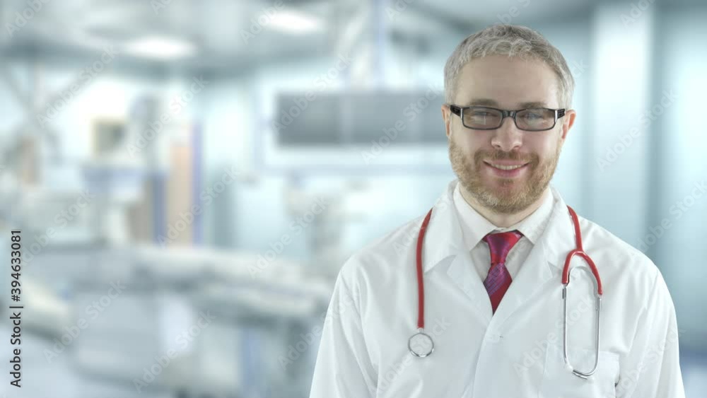 Smiling cheerful doctor in the operating theatre of a hospital Smiling cheerful doctor in the operating theatre of a hospital