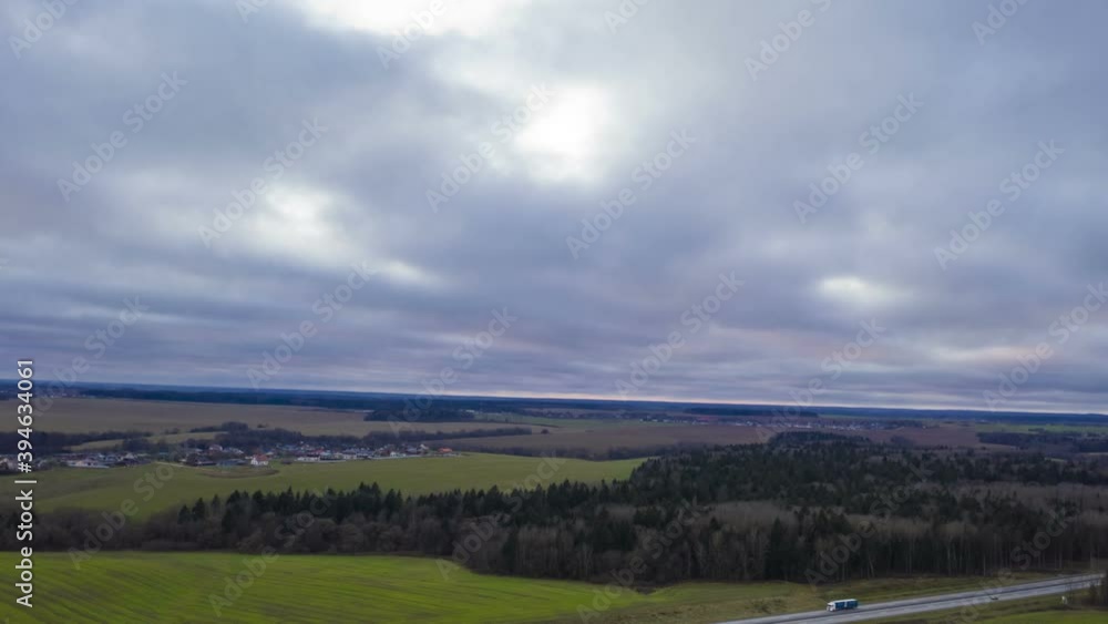 Aerial view of agricultural landscape with fields and forest in autumn season. Beautiful rural landscape in bird's-eye view, hyperlapse.
