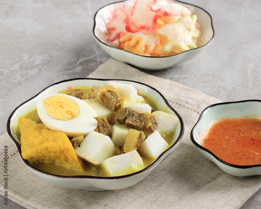 Lontong Kari Sapi or Indonesian Beef Curry with Rice Cake. Street Food Popular for Breakfast in West Java, Indonesia Lontong Kari Sapi or Indonesian Beef Curry with Rice Cake. Street Food Popular for Breakfast in West Java, Indonesia