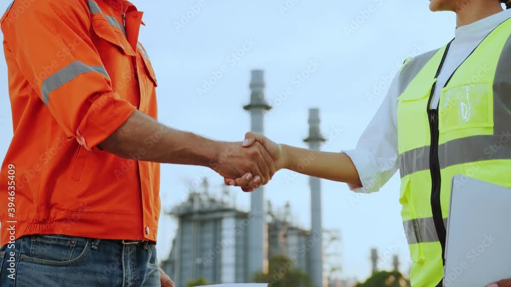 confident engineer and contractor successful business achievement hand shaking together with background of oil refinery power plant industrial ideas concept confident engineer and contractor successful business achievement hand shaking together with background of oil refinery power plant industrial ideas concept