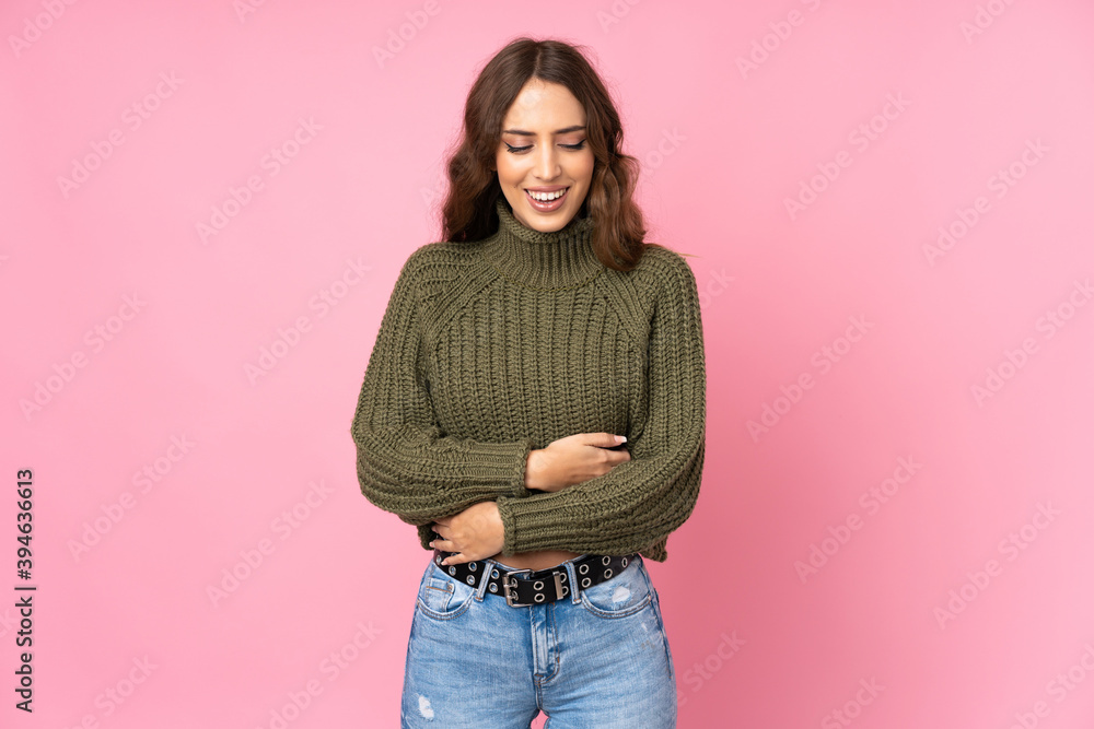 Young woman over isolated pink background smiling a lot