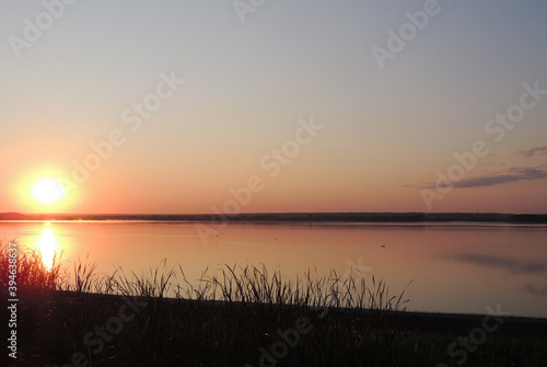 The sky at dawn is reflected in the lake 