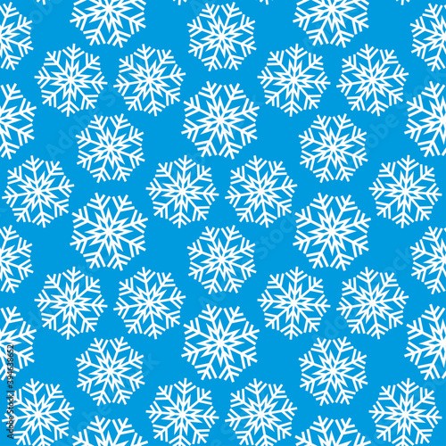 Beautiful white snowflakes isolated on a bluish background. Cute festive snowy seamless pattern. Vector flat graphic illustration. Christmas texture.