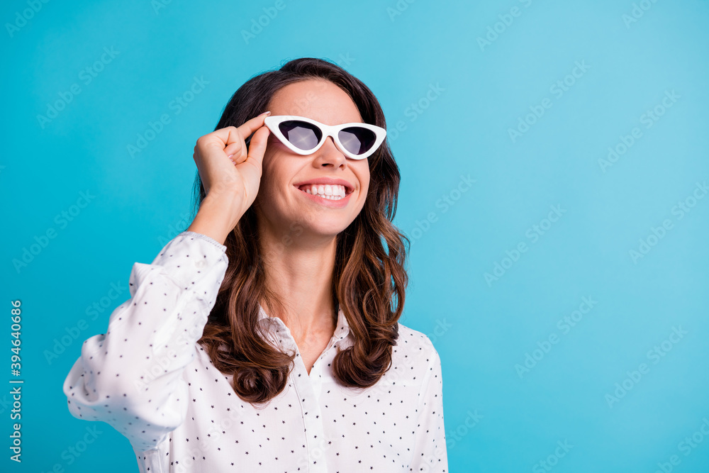 Portrait of optimistic brunette girl touch spectacles look empty space wear shirt isolated on teal color background Portrait of optimistic brunette girl touch spectacles look empty space wear shirt isolated on teal color background