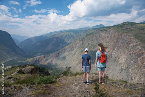 Woman an her son on the viewpoint of valley of the river of Chulyshman. Altai mountains, Russia, beautiful summer day, Travel concept