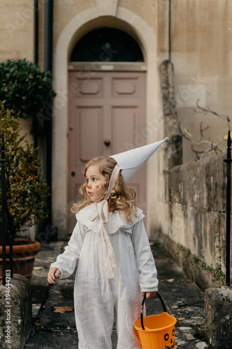 Little girl outside dressed up as a clown