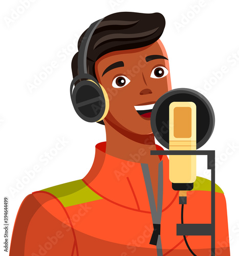 Young tanned guy broadcasting using modern professional equipment Young man in jacket with headphones. Cartoon character, blogger. Brunette with white-toothed smile. Guy blogger chats via microphone