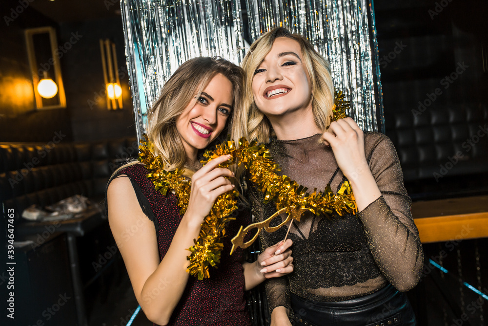 Portrait of happy young female friends together at nightclub Portrait of happy young female friends together at nightclub