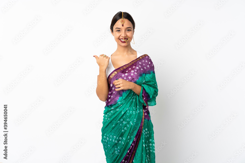 Young indian woman isolated on white background pointing to the side to present a product Young indian woman isolated on white background pointing to the side to present a product