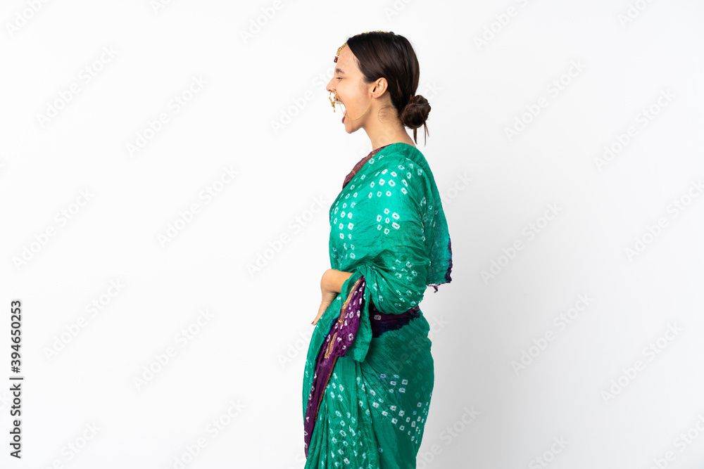 Young indian woman isolated on white background laughing in lateral position Young indian woman isolated on white background laughing in lateral position