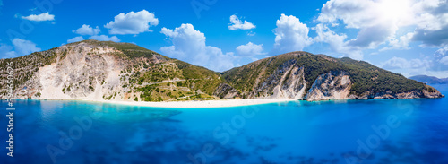 Wide panoramic aerial view to Myrtos beach and the coast of Kefalonia, Greece, with turquoise sea and sunshine during summer time
