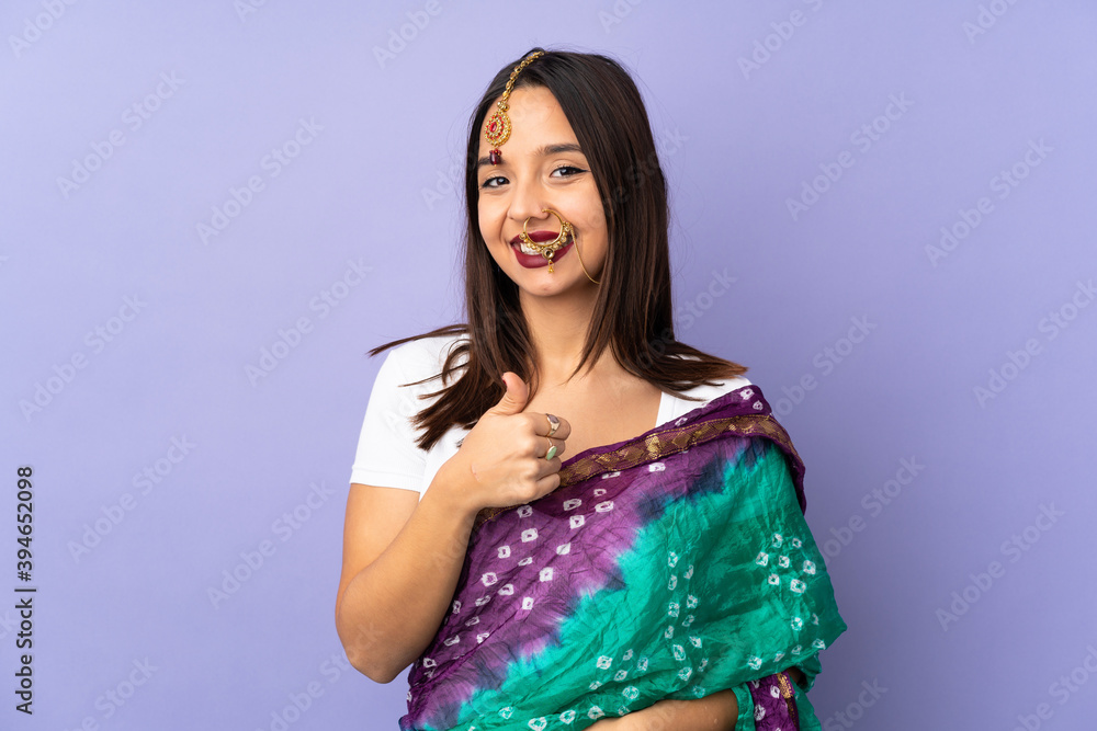 Young Indian woman isolated on purple background giving a thumbs up gesture Young Indian woman isolated on purple background giving a thumbs up gesture
