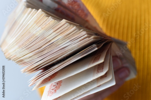 Five-thousandth of banknotes in his hand