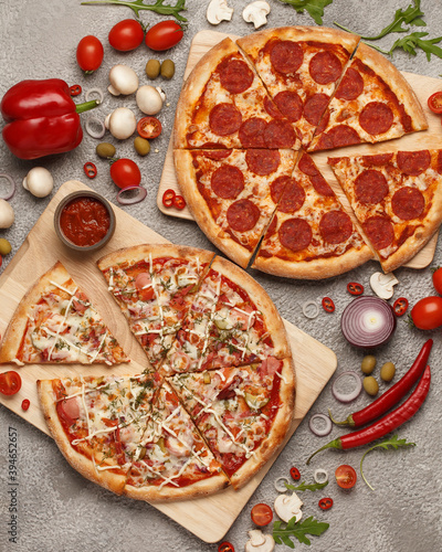 Italian pizza. Classic round pizza. Pizza and slices. Pizza on bright backgrounds with ingredients.