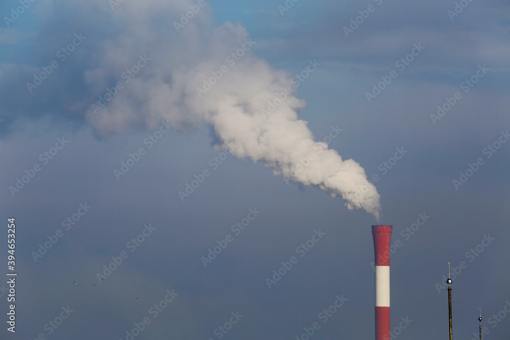 Smoke rises from a industrial chimney during a foggy morning in the city of Belgrade, Serbia.