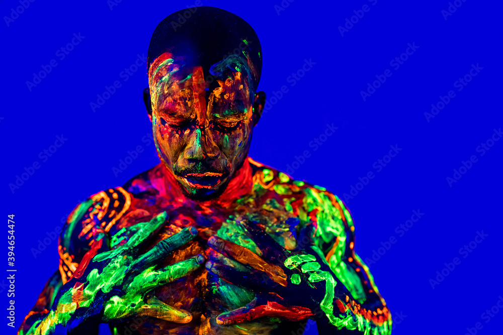 afro american man with UV body art posing in studio afro american man with UV body art posing in studio