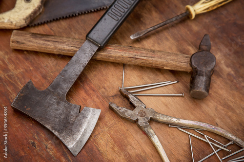 Old rusty tools closeup on wooden grunge rough background