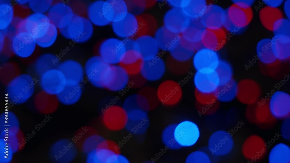 Abstract bokeh background of Christmas night, blue red lights outdoor. Round colorful bokeh Shine in the dark, 4K Video Abstract bokeh background of Christmas night, blue red lights outdoor. Round colorful bokeh Shine in the dark, 4K Video