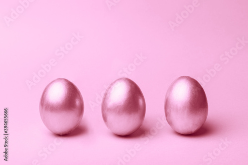 Silver easter eggs on a pink background.