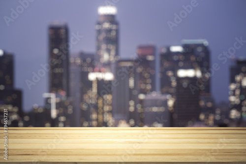 Blank tabletop made of wooden planks with beautiful blurry cityscape at twilight on background, mockup © Pixels Hunter