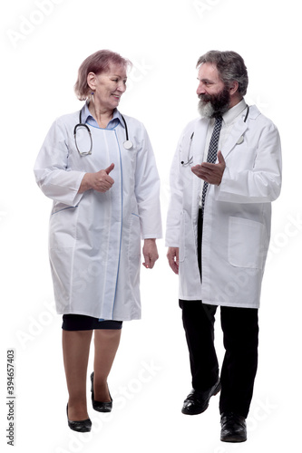 smiling medical colleagues walking together. isolated on a white