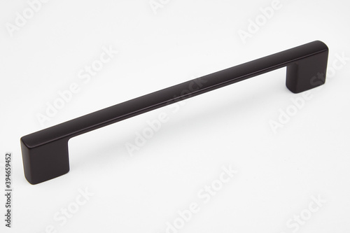 Black metallic door handle on white background