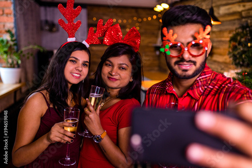 Photography group indian friends cheering with champagne flutes and making selfie photos on