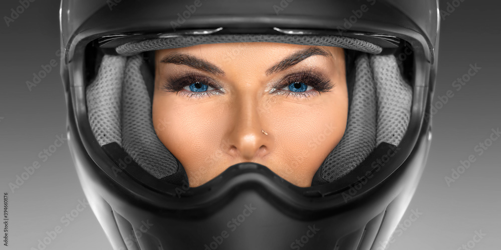 Close-up portrait of a woman in a motorcycle helmet.