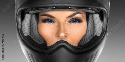 Close-up portrait of a woman in a motorcycle helmet.