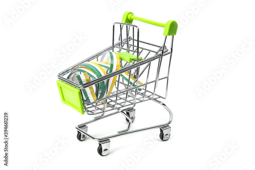 closeup on supermarket shopping cart isolated with a Irish tricolor ribbon