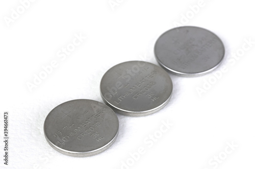 Lithium batteries of various sizes arranged on white background