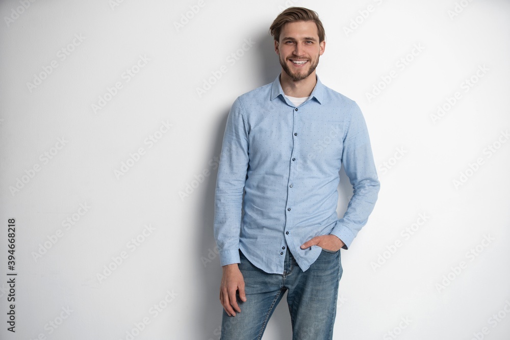 Portrait of a smart young man standing against white background. Portrait of a smart young man standing against white background.
