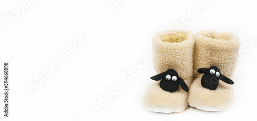 Warm Christmas ugg boots in the shape of a lamb. Slippers stockings on a white background.