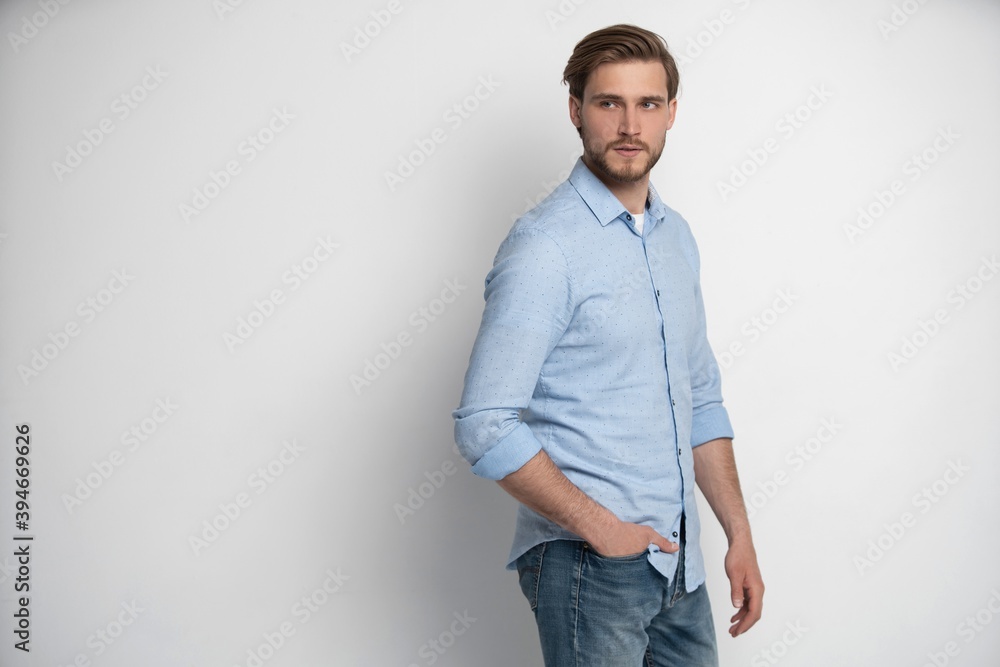 Portrait of a smart young man standing against white background. Portrait of a smart young man standing against white background.