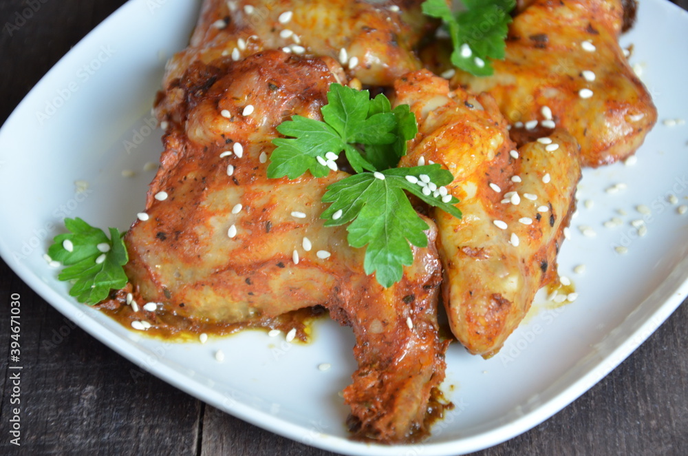 Spicy hot chicken wings cooked with honey and soy, topped with sesame seeds, served with sauce, celery and carrot sticks Spicy hot chicken wings cooked with honey and soy, topped with sesame seeds, served with sauce, celery and carrot sticks