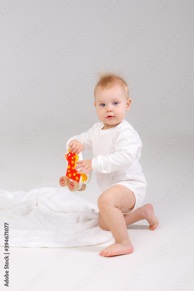 baby playing with a colorful toy isolated on a white background baby playing with a colorful toy isolated on a white background