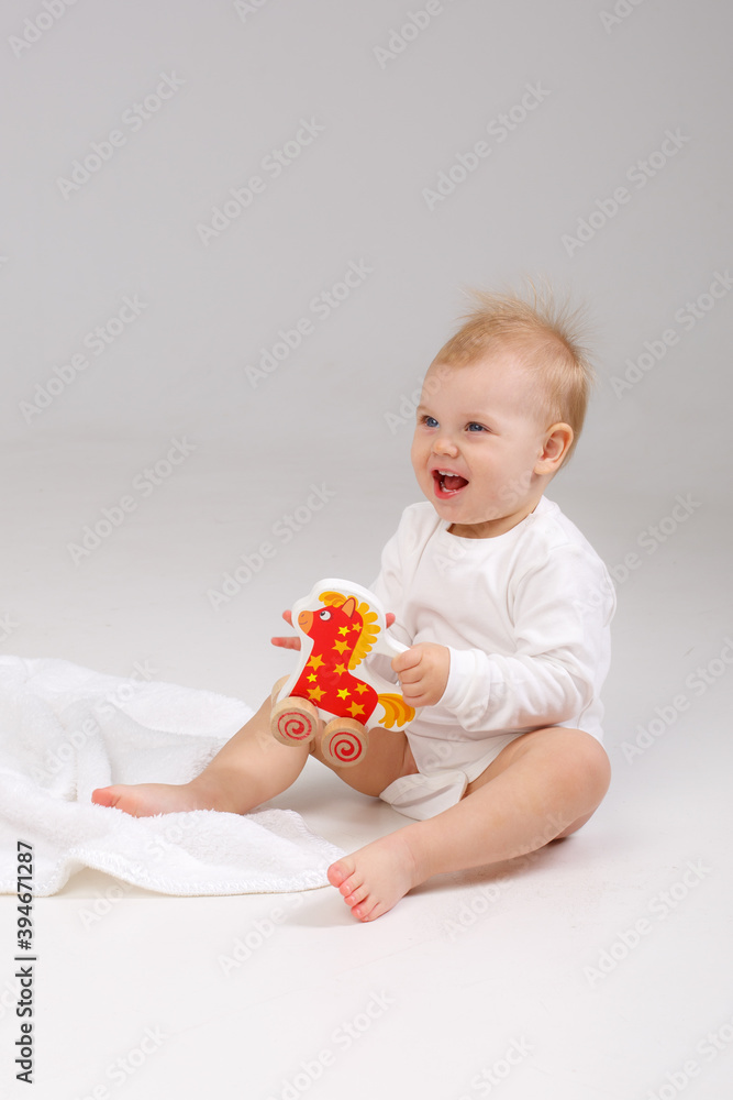 baby playing with a colorful toy isolated on a white background