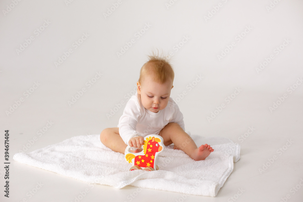 baby playing with a colorful toy isolated on a white background baby playing with a colorful toy isolated on a white background