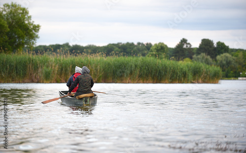 two fishermen in a boat going fishing