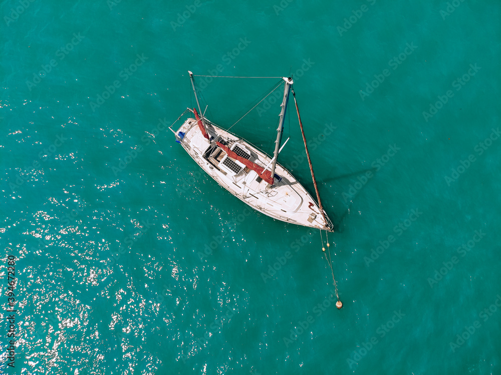 Fototapeta premium Amazing sail boat is sailing across the deep blue sea. Top view.