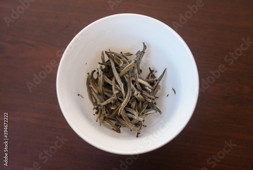 Bai Hao Yin Zhen (White Hair Silver Needle) white tea leaves in a gaiwan/Zhong ready for Gong Fu Cha brewing, traditional asian way of steeping. Beautiful dry full leaves perfectly processed. Top view